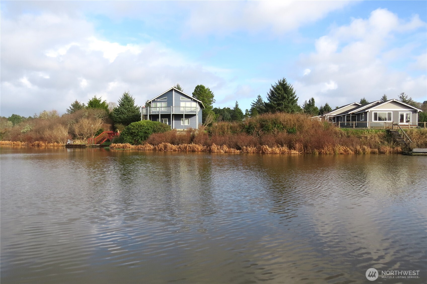 636 Weatherwax Loop Northeast Ocean Shores, WA 98569 - Photo 13 of 32 a view of a lake with houses
