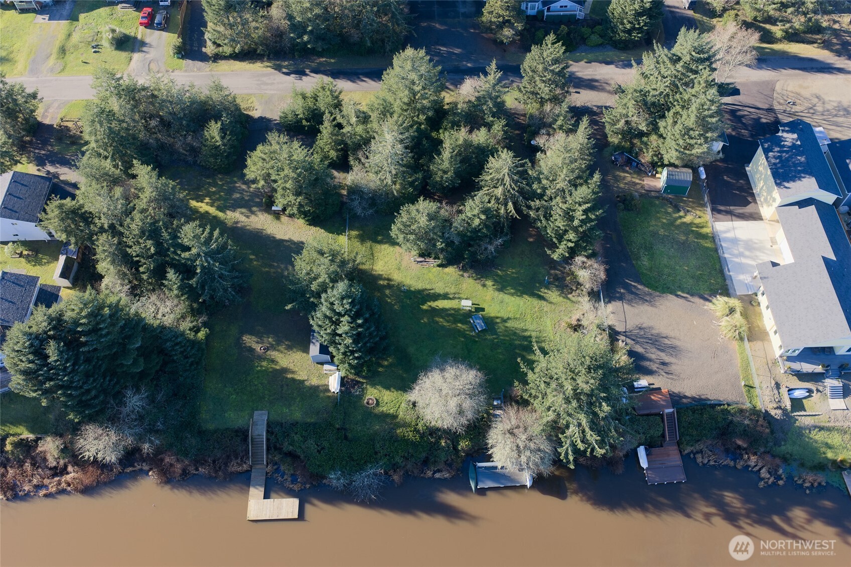 636 Weatherwax Loop Northeast Ocean Shores, WA 98569 - Photo 32 of 32 an aerial view of a house with a yard and lake view