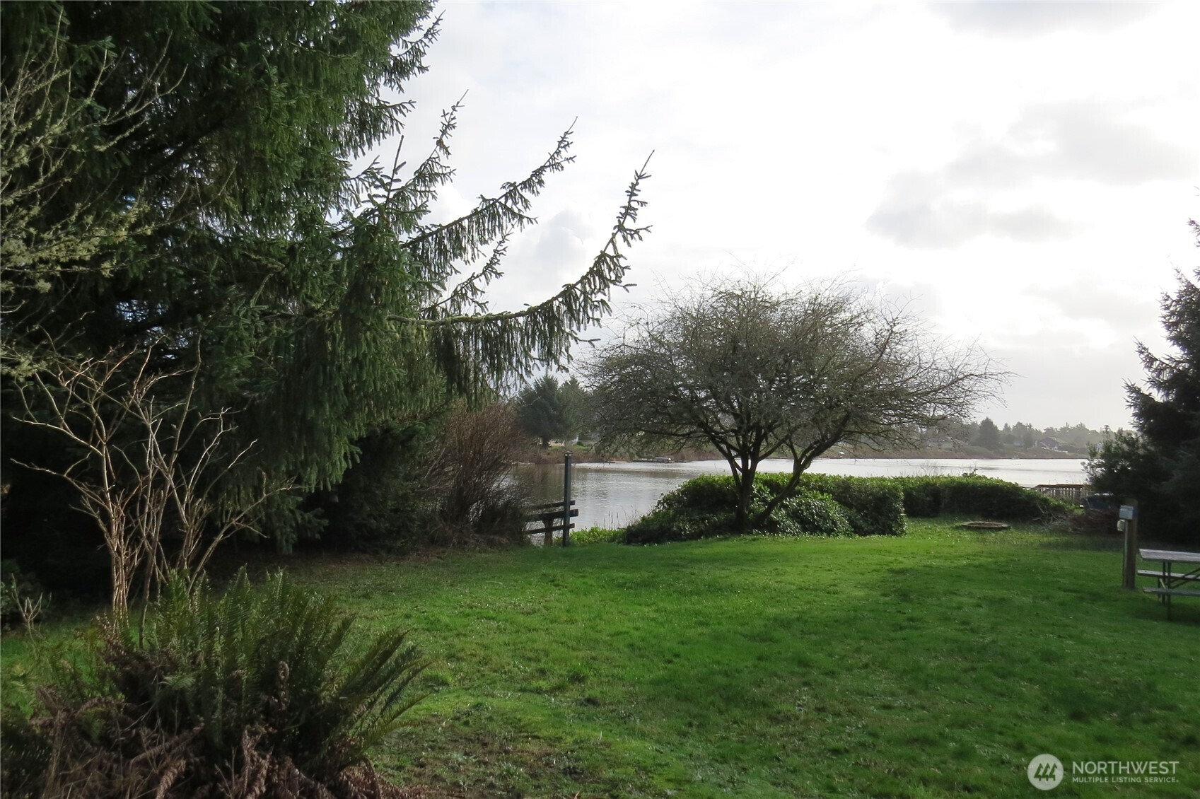 636 Weatherwax Loop Northeast Ocean Shores, WA 98569 - Photo 9 of 32 a view of a garden with a fountain