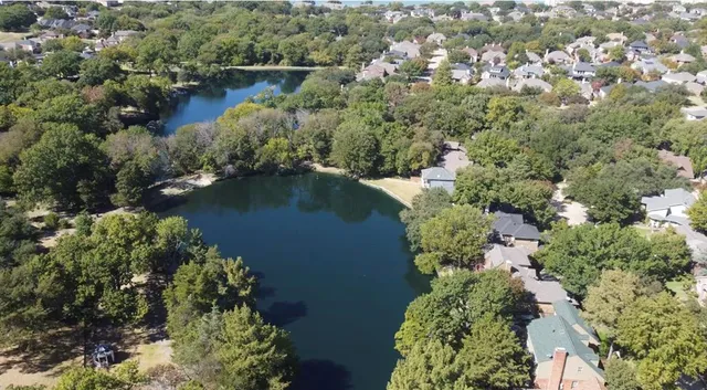 an aerial view of lake residential house with outdoor space and trees around
