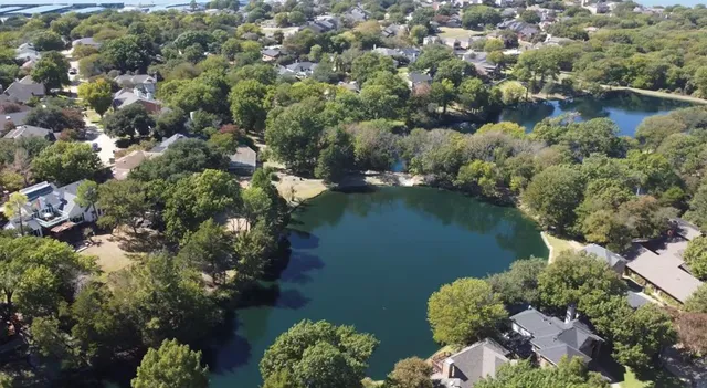 an aerial view of a houses with outdoor space and lake view