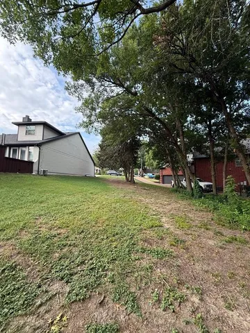 a view of outdoor space with playground and green space
