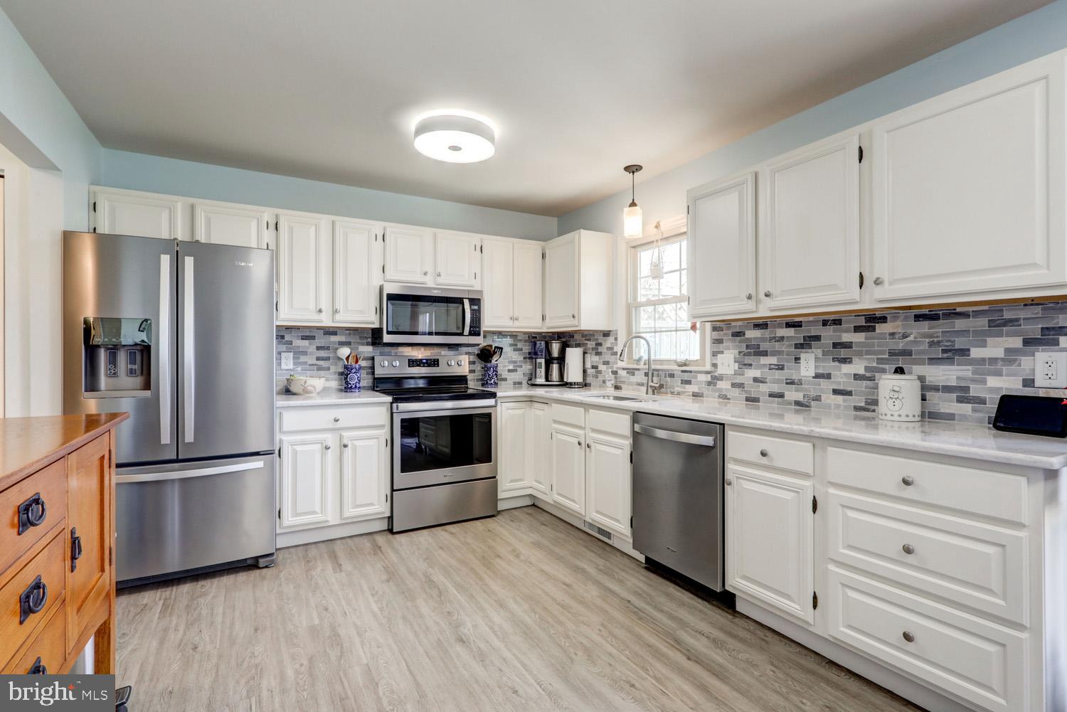 34 Brookview Drive Lititz, PA 17543 - Photo 11 of 36 a kitchen with granite countertop white cabinets and stainless steel appliances