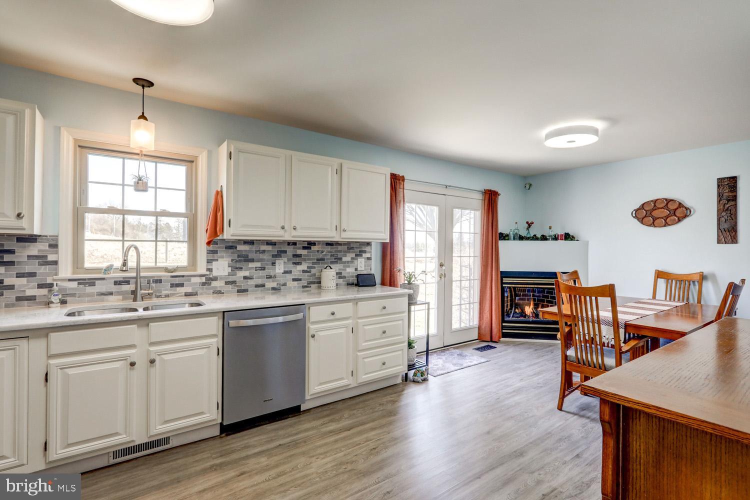 34 Brookview Drive Lititz, PA 17543 - Photo 14 of 36 a kitchen with cabinets a sink dishwasher a stove and a refrigerator with wooden floor