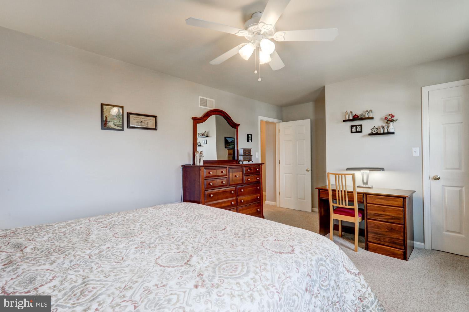 34 Brookview Drive Lititz, PA 17543 - Photo 17 of 36 a bedroom with a bed and a chandelier
