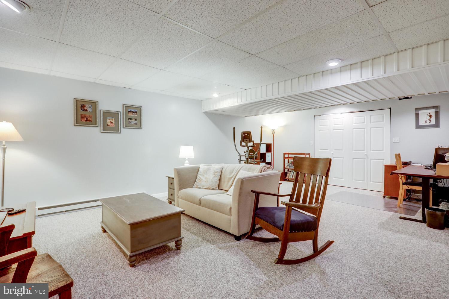 34 Brookview Drive Lititz, PA 17543 - Photo 25 of 36 a living room with furniture and a dining table with wooden floor