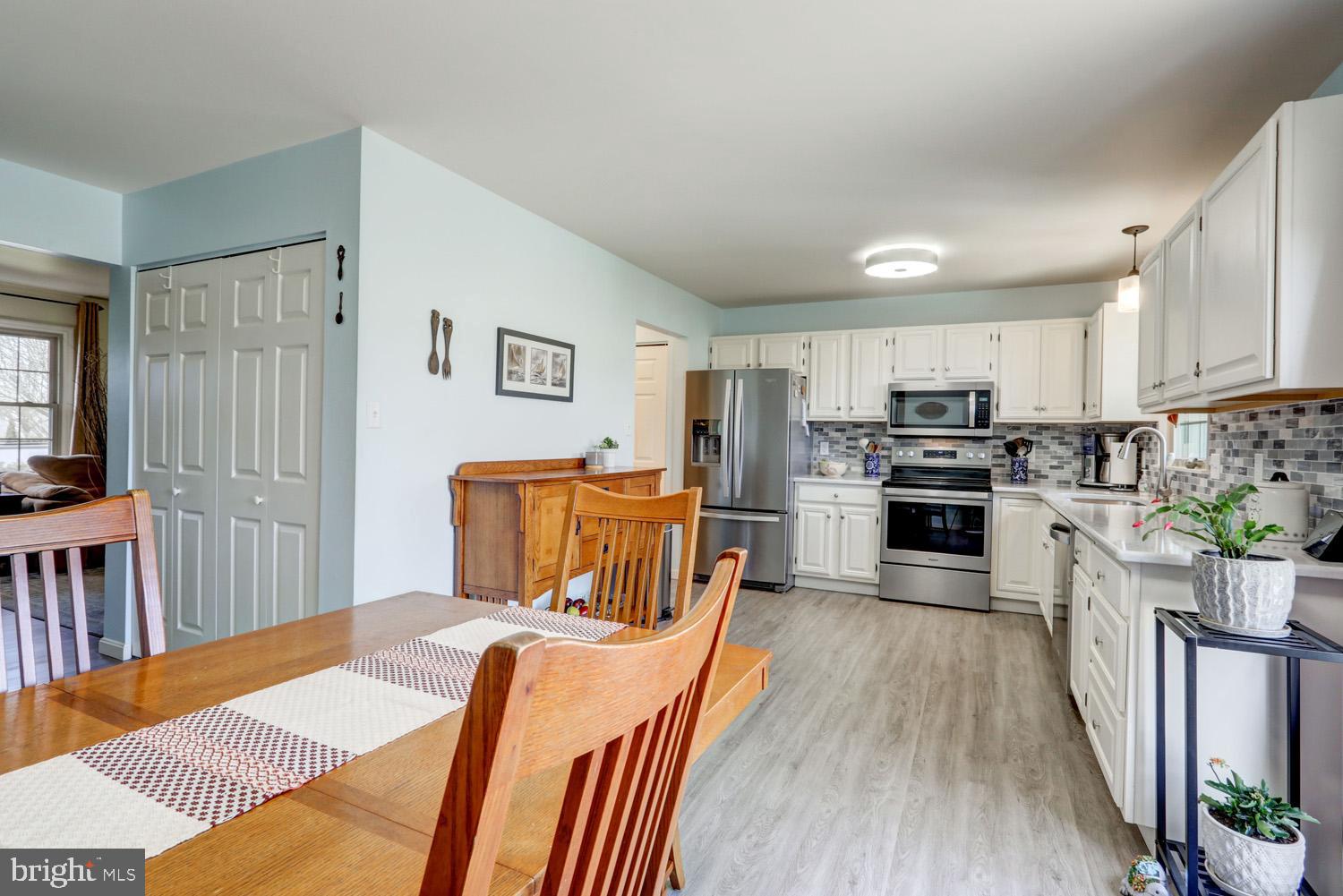 34 Brookview Drive Lititz, PA 17543 - Photo 10 of 36 a kitchen with stainless steel appliances a stove a sink dishwasher a refrigerator with white cabinets and wooden floor