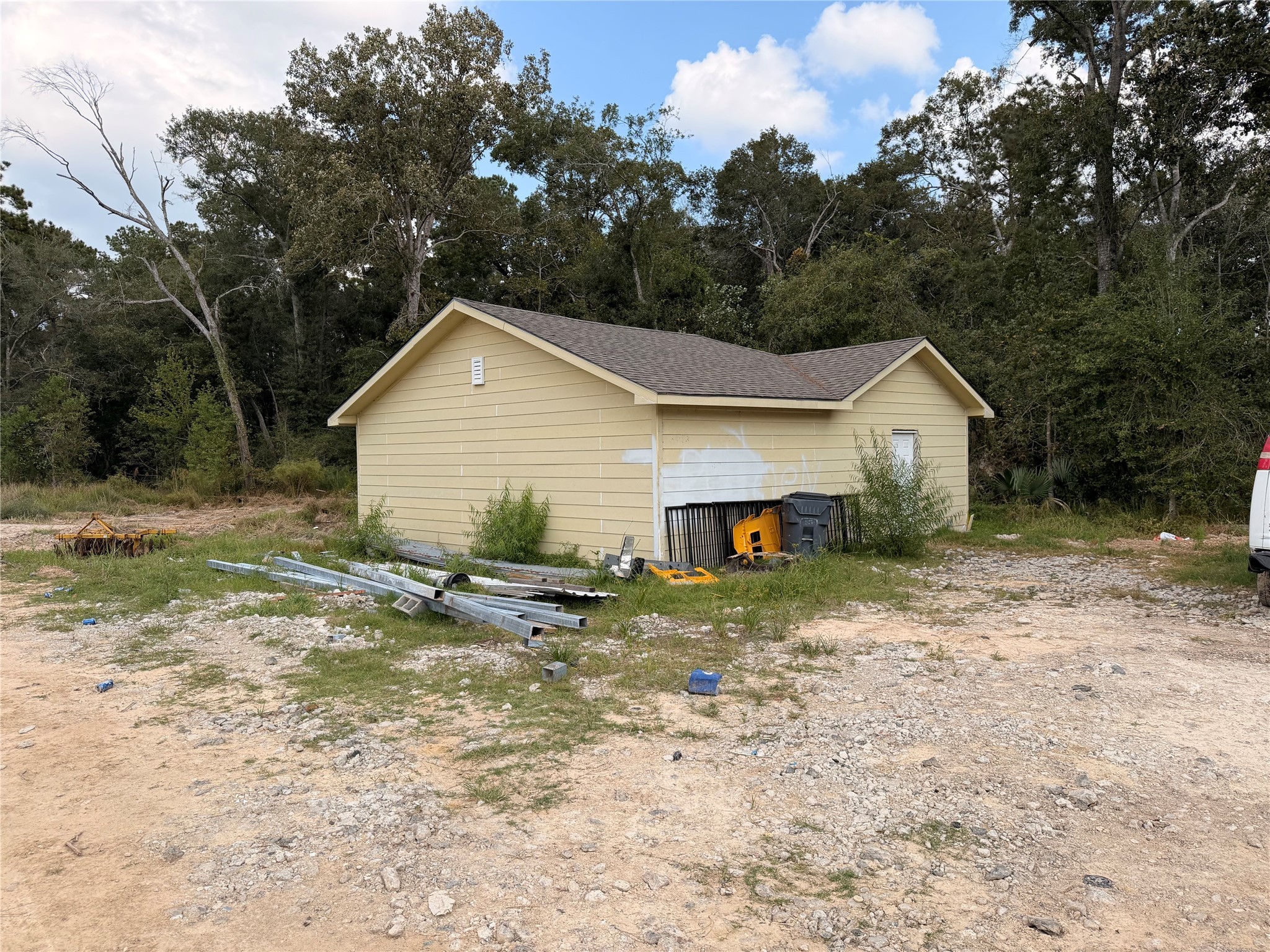 62 Short Leaf Drive Huffman, TX 77336 - Photo 6 of 33 a view of a small white house next to a yard with large tree
