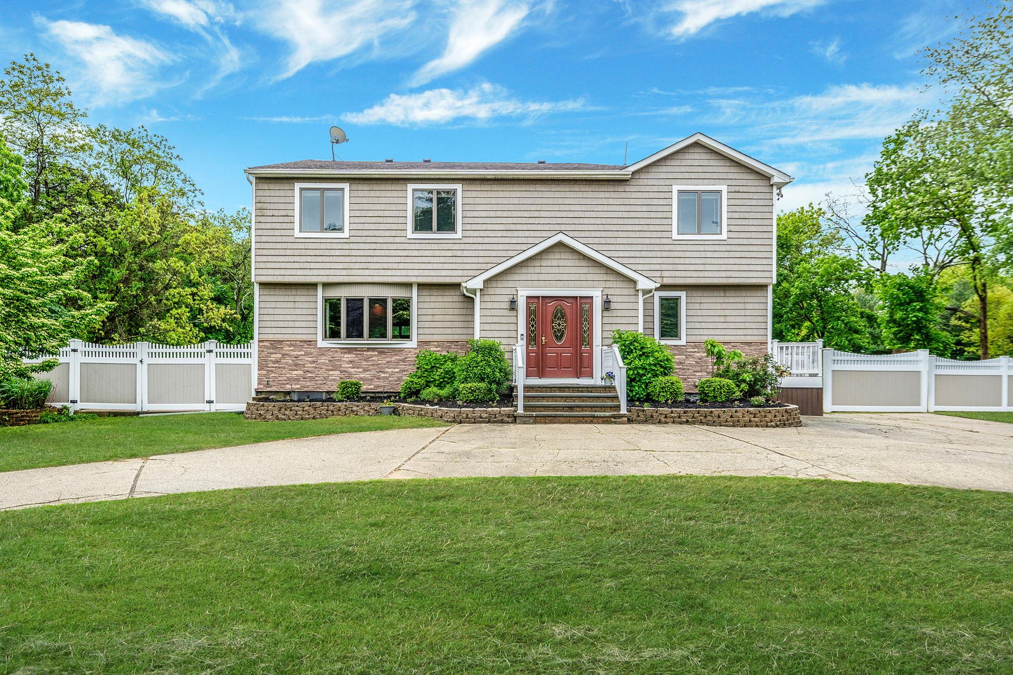 170 Oceanside Street Islip Terrace, NY 11752 - Photo 1 of 1 a front view of a house with a garden and yard