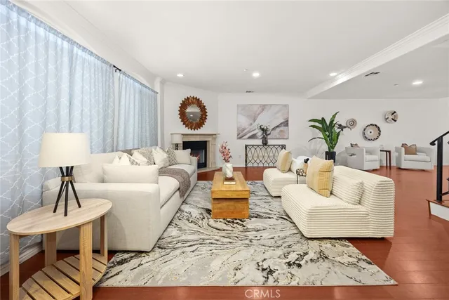 a living room with fireplace furniture and a wooden floor