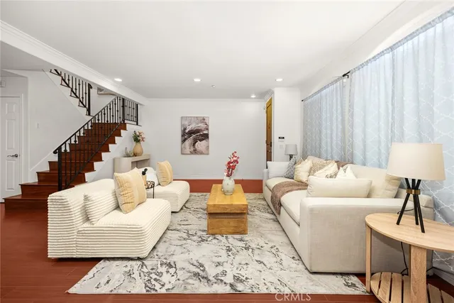 a living room with furniture and a potted plant