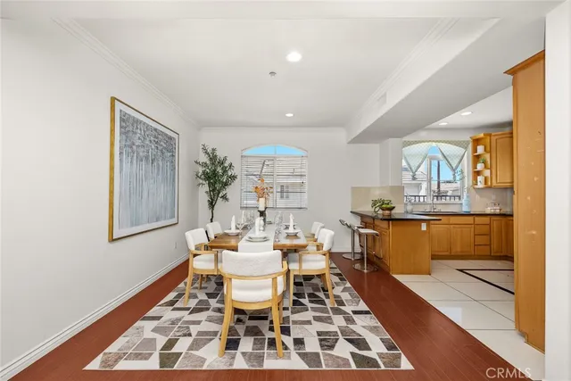 a dining room with furniture a table and kitchen view