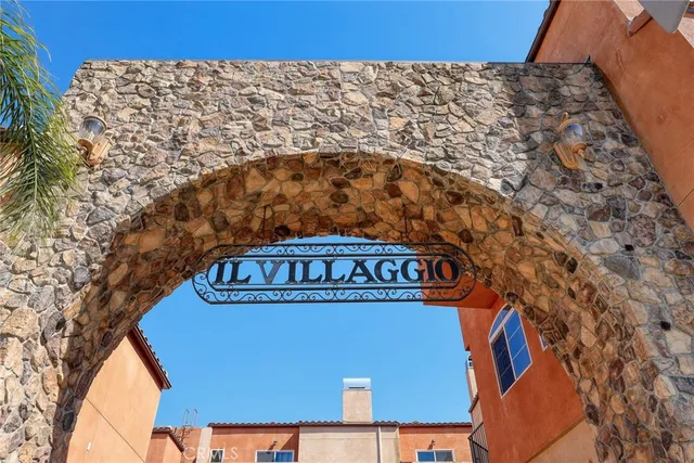 a sign on road next to a building