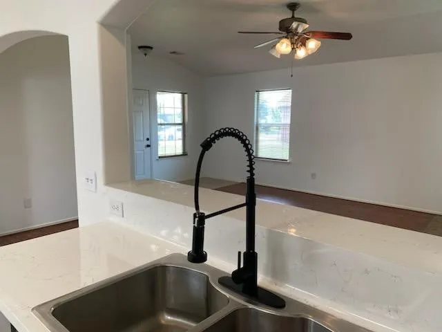 a kitchen with a faucet a chandelier