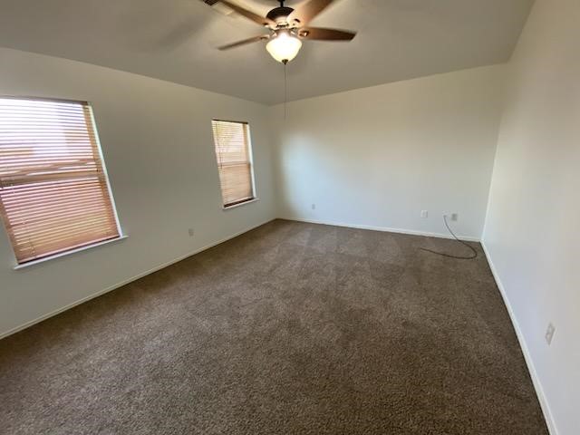 9530 Alex Springs Lane Houston, TX 77044 - Photo 2 of 8 an empty room with windows and fan