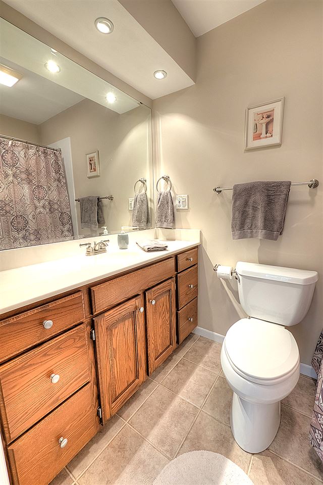 3506 North View Road Rockford, IL 61114 - Photo 16 of 25 a bathroom with a toilet a sink and mirror