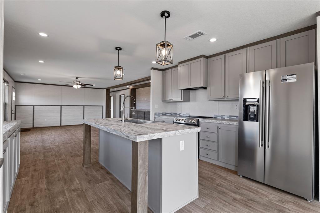 3888 Sandusky Road Whitesboro, TX 76273 - Photo 8 of 24 Kitchen with stainless steel appliances, gray cabinets, dark wood finished floors, and a ceiling fan