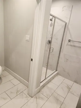 a bathroom with a glass shower door
