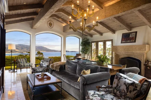 a view of a patio with couches table and chairs and potted plants