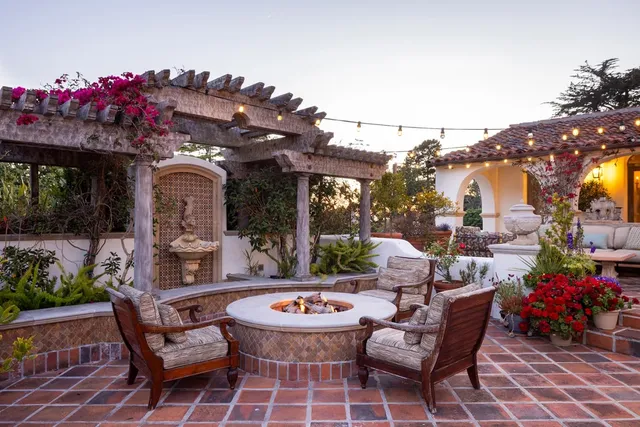a dining room with wooden floor a chandelier a wooden table and chairs