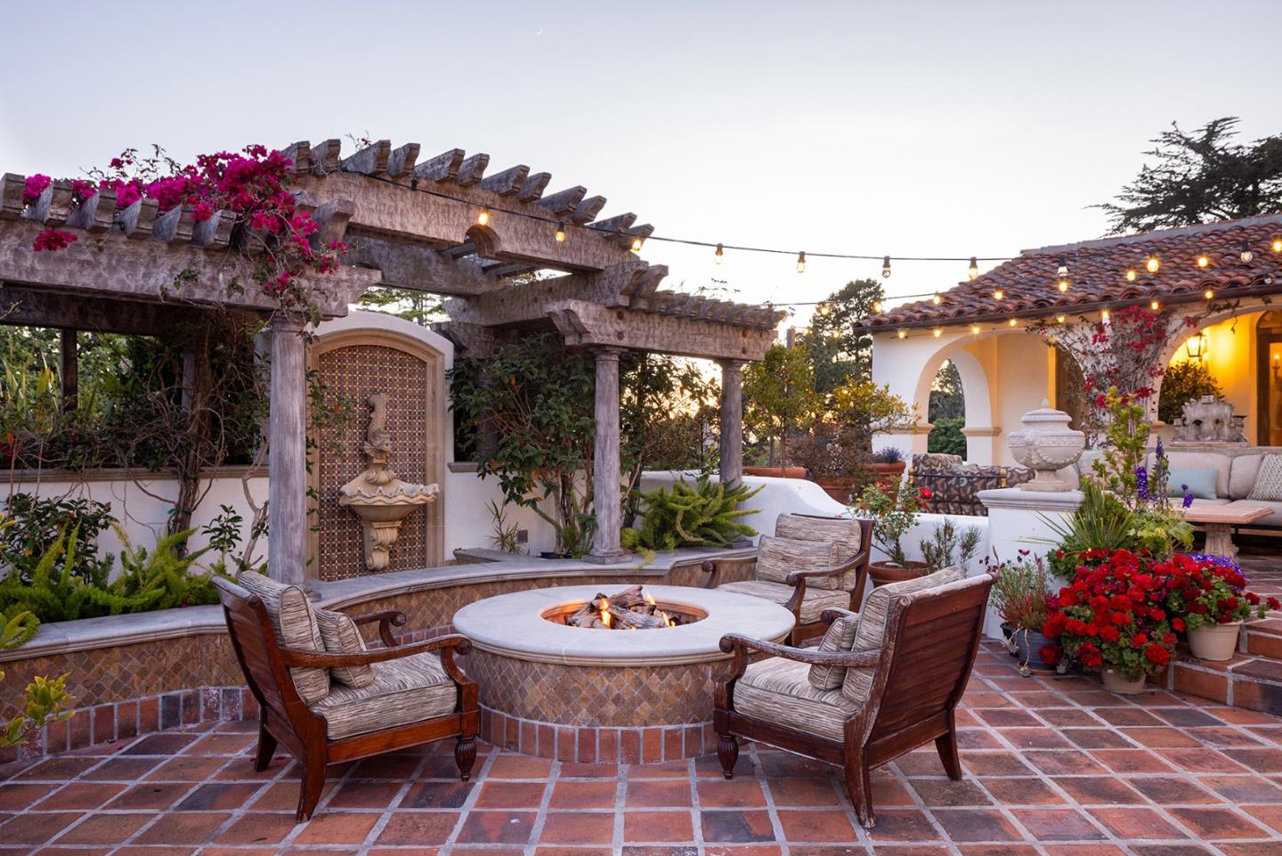 1463 Oleada Road Pebble Beach, CA 93953 - Photo 25 of 68 a view of a patio with couches table and chairs and potted plants