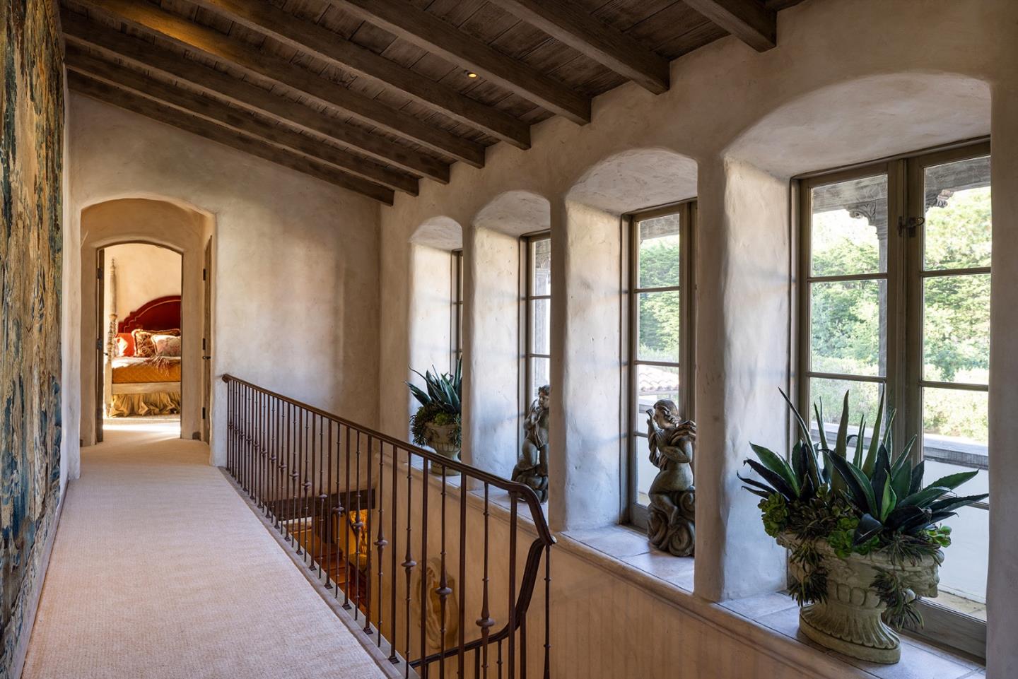 1463 Oleada Road Pebble Beach, CA 93953 - Photo 44 of 68 a view of a hallway with wooden floor and stairs