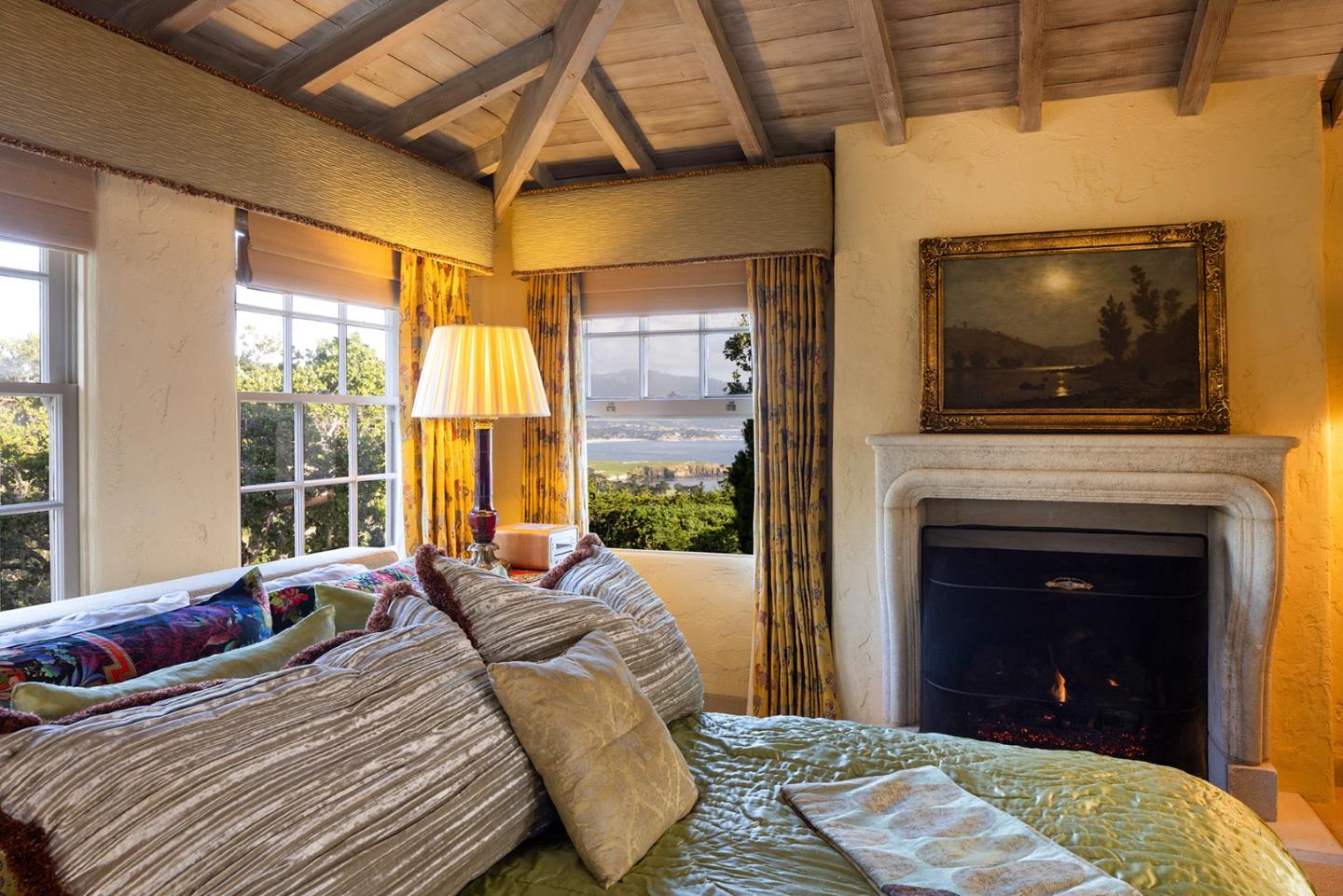 1463 Oleada Road Pebble Beach, CA 93953 - Photo 65 of 68 a bedroom with a bed and a fireplace