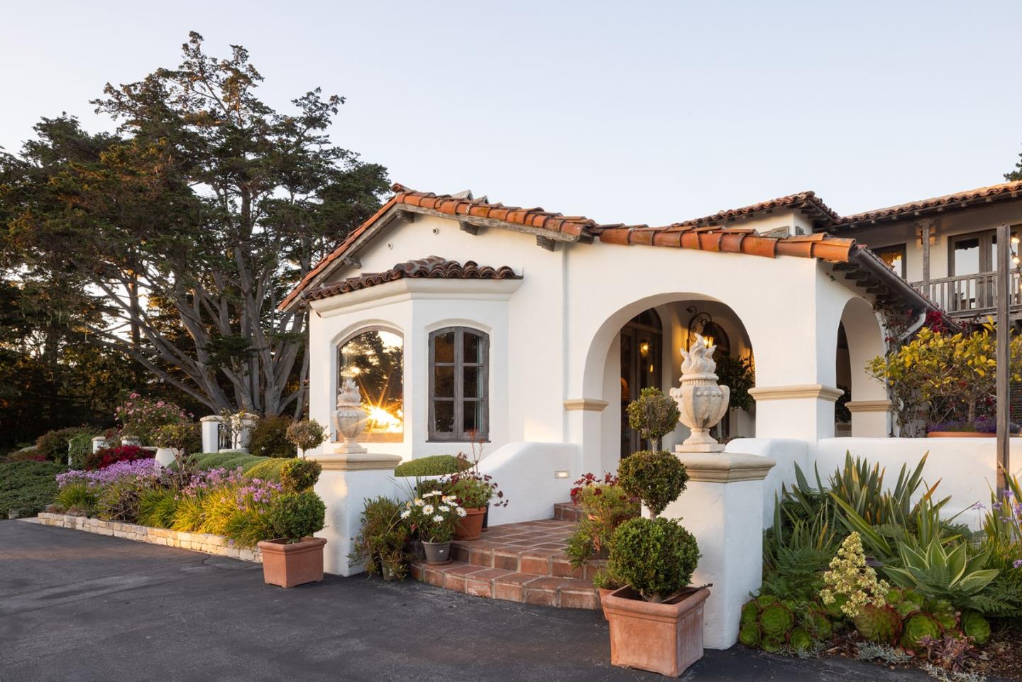 1463 Oleada Road Pebble Beach, CA 93953 - Photo 8 of 68 a front view of a house with a yard