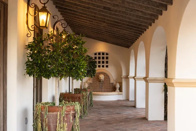 a view of a patio with table and chairs potted plants