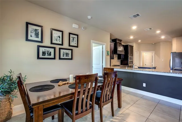 a view of a dining room with furniture and chandelier