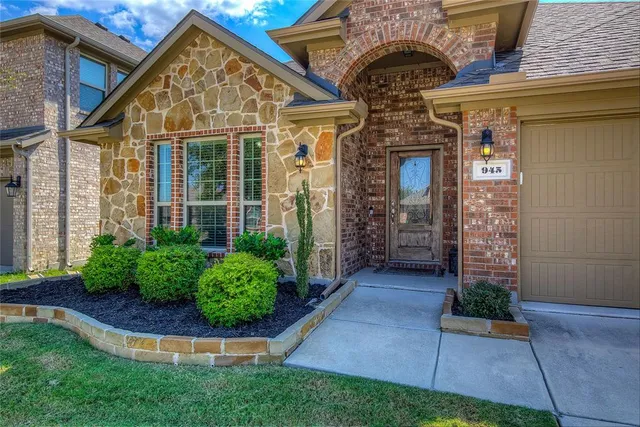a view of a house with potted plants and a yard
