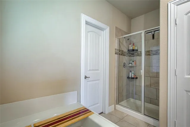 a bathroom with a bathtub and a shower