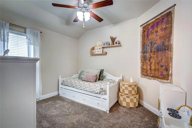 a living room with furniture and a baby crib