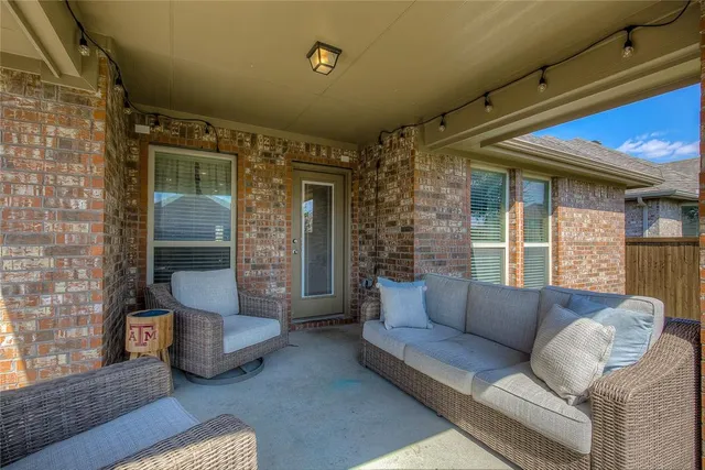 a view of a patio with couches chairs and a yard