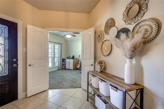 a living room with furniture a mirror and a clock on the wall
