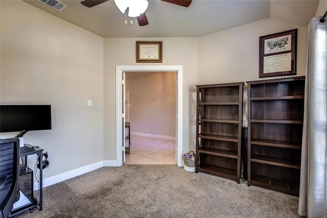 a view of an empty room with a cabinet and a window