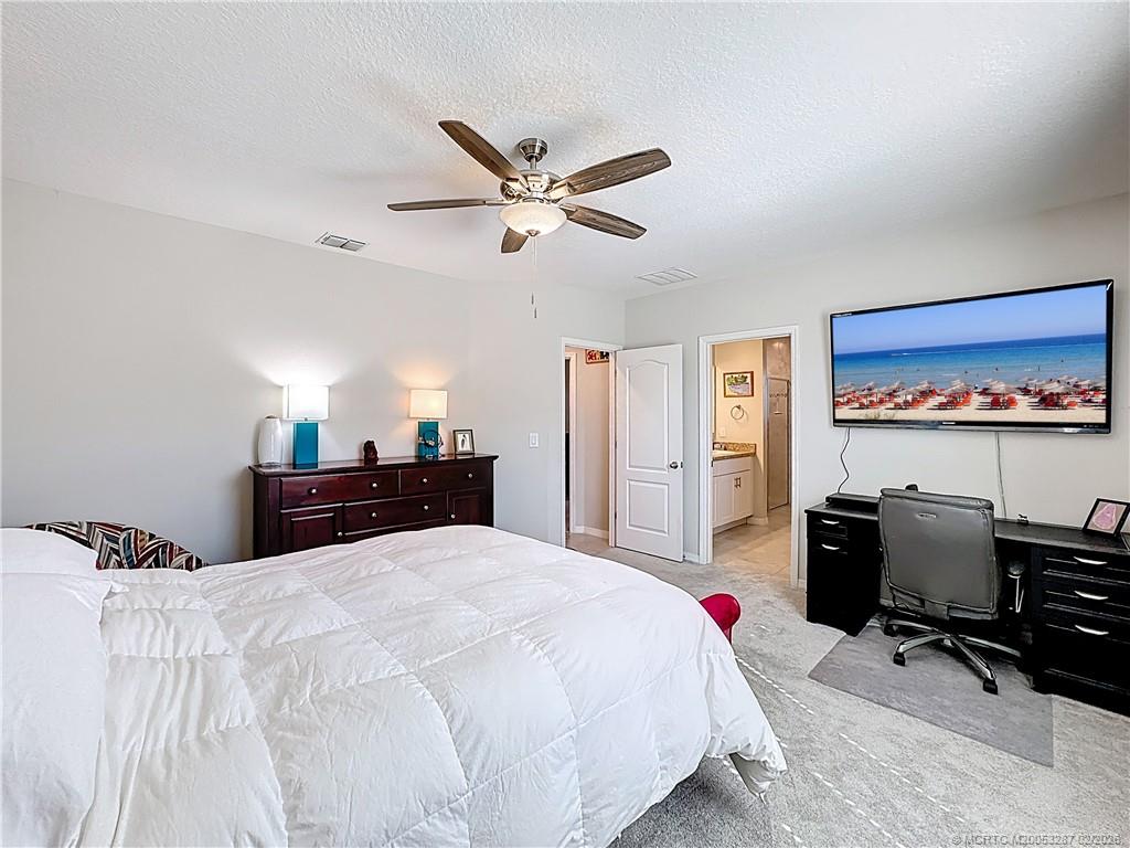 4341 Southwest Appleseed Road Port St. Lucie, FL 34953 - Photo 7 of 25 a bed room with a bed and dresser
