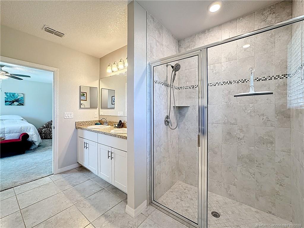4341 Southwest Appleseed Road Port St. Lucie, FL 34953 - Photo 9 of 25 a spacious bathroom with a shower sink and mirror