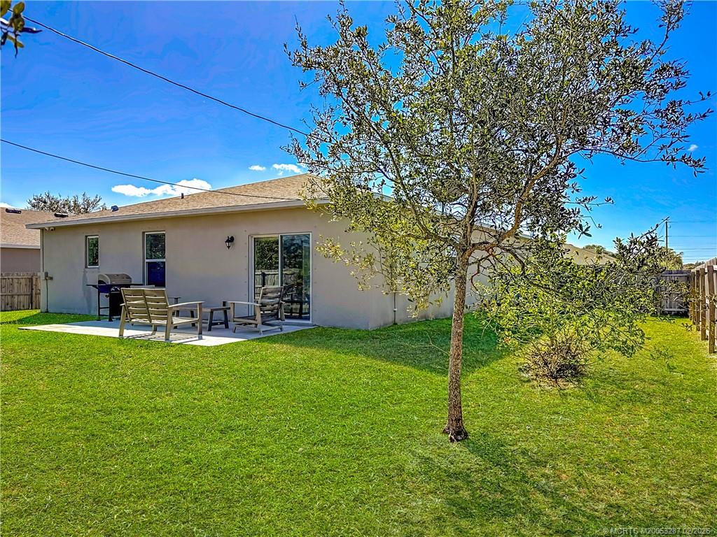 4341 Southwest Appleseed Road Port St. Lucie, FL 34953 - Photo 16 of 25 a view of a house with backyard porch and sitting area