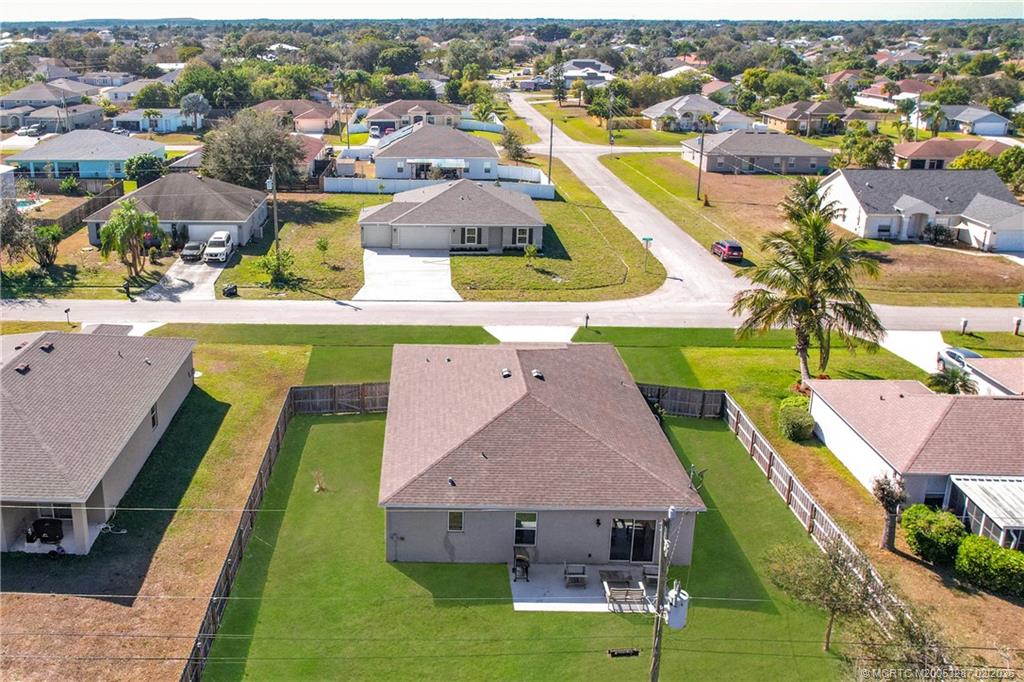 4341 Southwest Appleseed Road Port St. Lucie, FL 34953 - Photo 18 of 25 an aerial view of residential houses with outdoor space