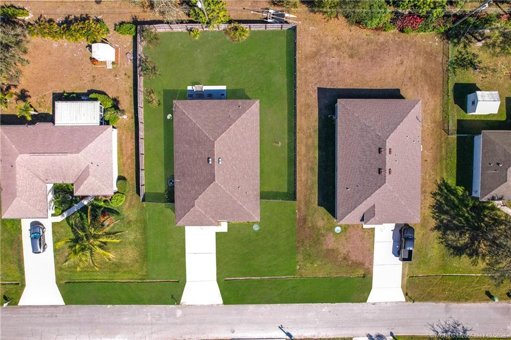 4341 Southwest Appleseed Road Port St. Lucie, FL 34953 - Photo 19 of 25 an aerial view of a house with a garden and plants