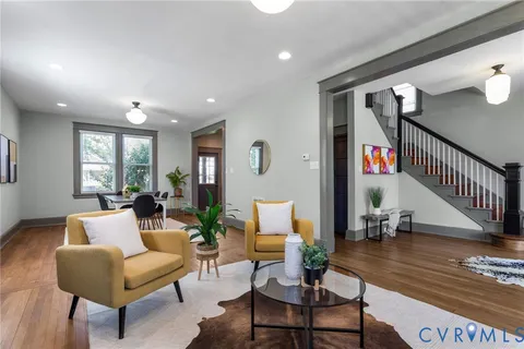 a kitchen with granite countertop stainless steel appliances a refrigerator a sink and white cabinets