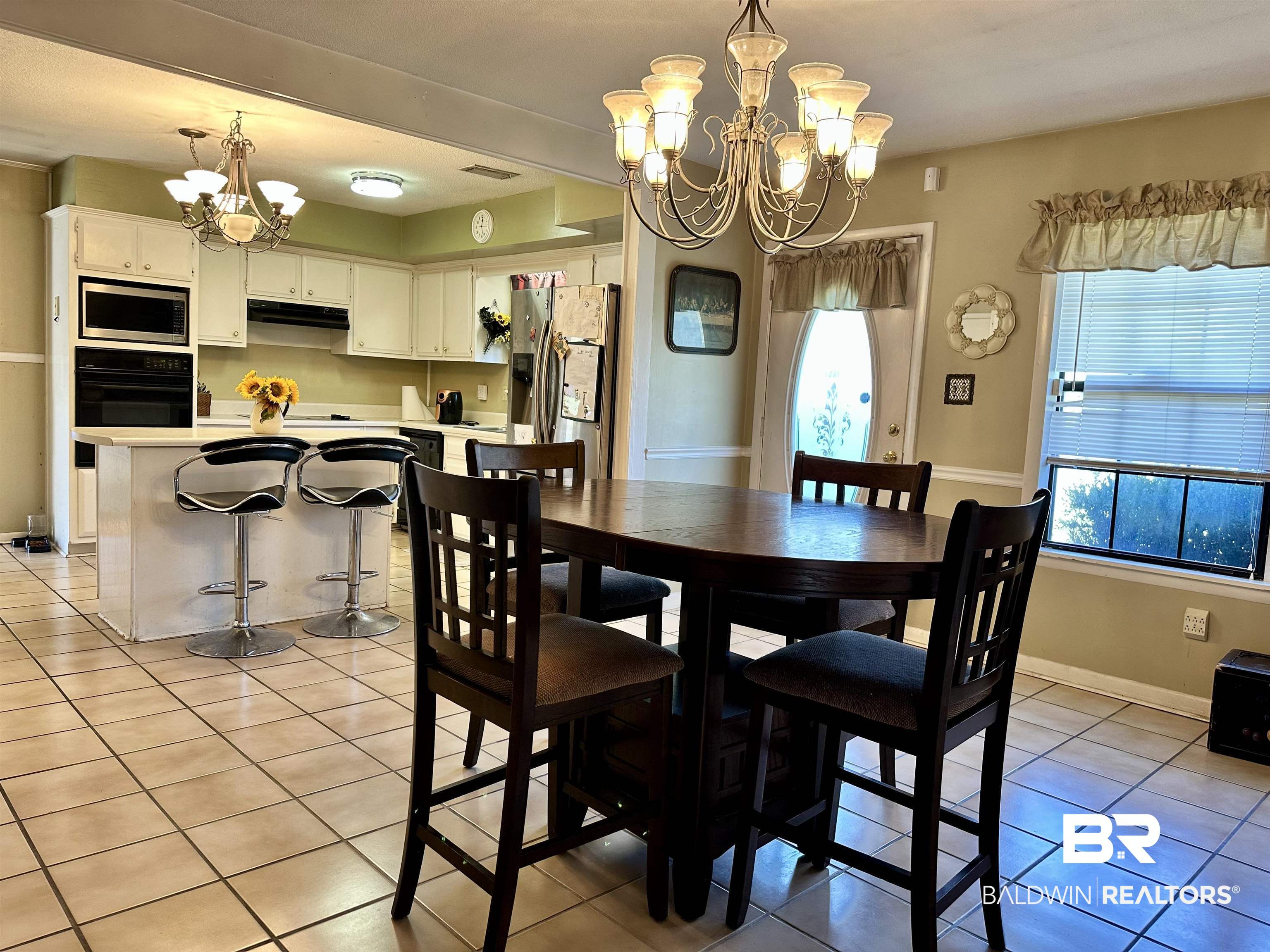 2593 Foshee Road Brewton, AL 36426 - Photo 2 of 15 Tiled dining room with a chandelier