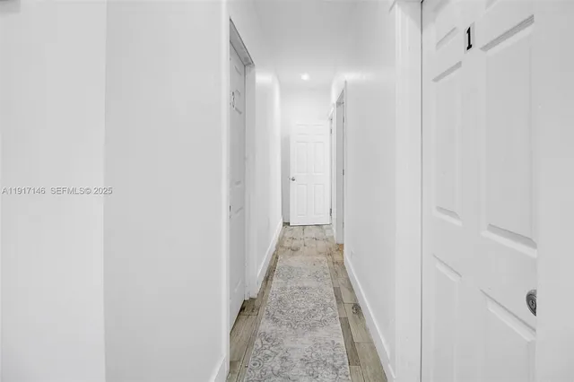 a view of a hallway with a white door