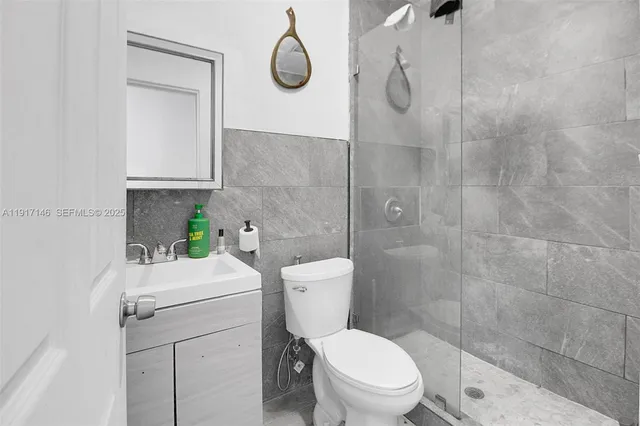 a bathroom with a toilet a sink and shower