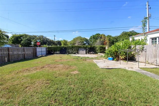 a front view of a house with a yard and potted plants