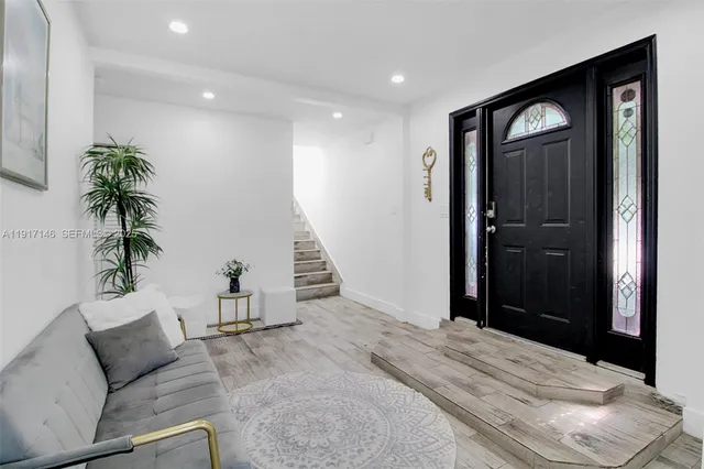 a view of an entryway with wooden floor