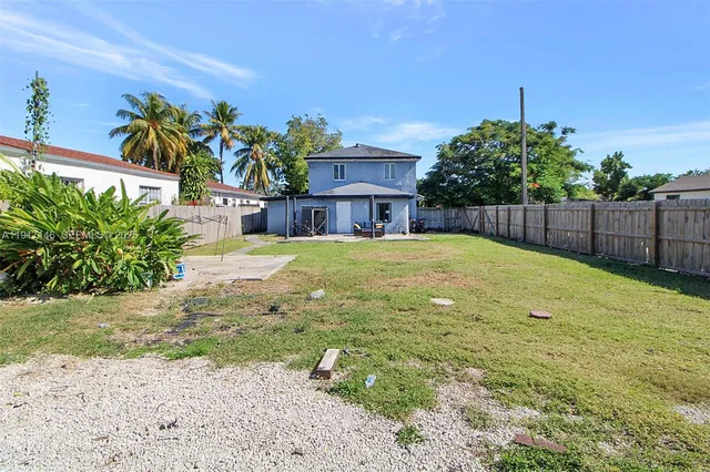 a view of a house with a yard and garage