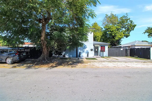 a view of a patio with furniture and a garden