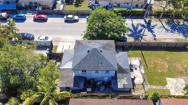 an aerial view of residential houses with outdoor space